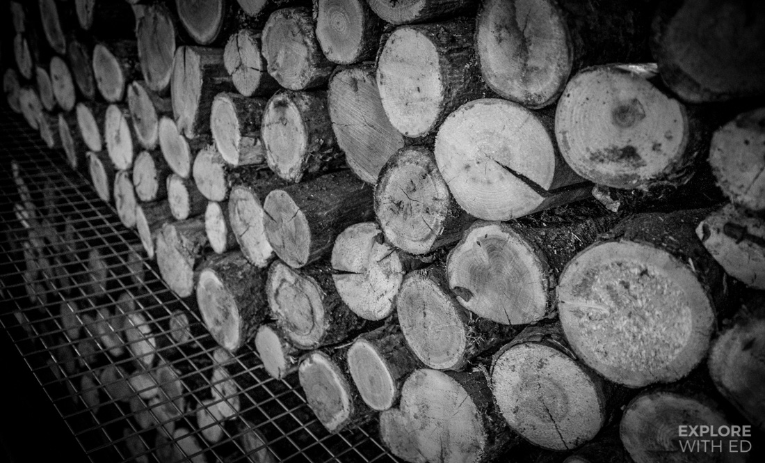 Shelving unit with logs of wood