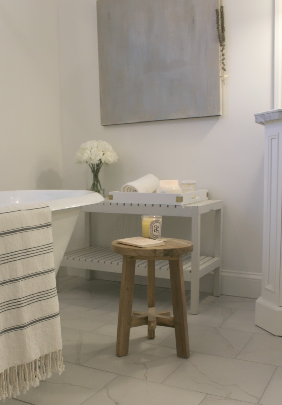 Bathroom with rustic teak stool and abstract painting by Hello Lovely Studio. Come see renovation photos in Before & After: My Home Renovation.