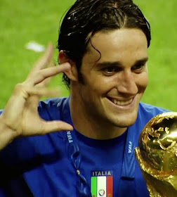 Luca Toni with the World Cup in 2006. The hand gesture is the one he habitually made after scoring a goal