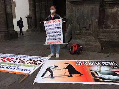 man protesting for justice in Plaza Grande, Quito