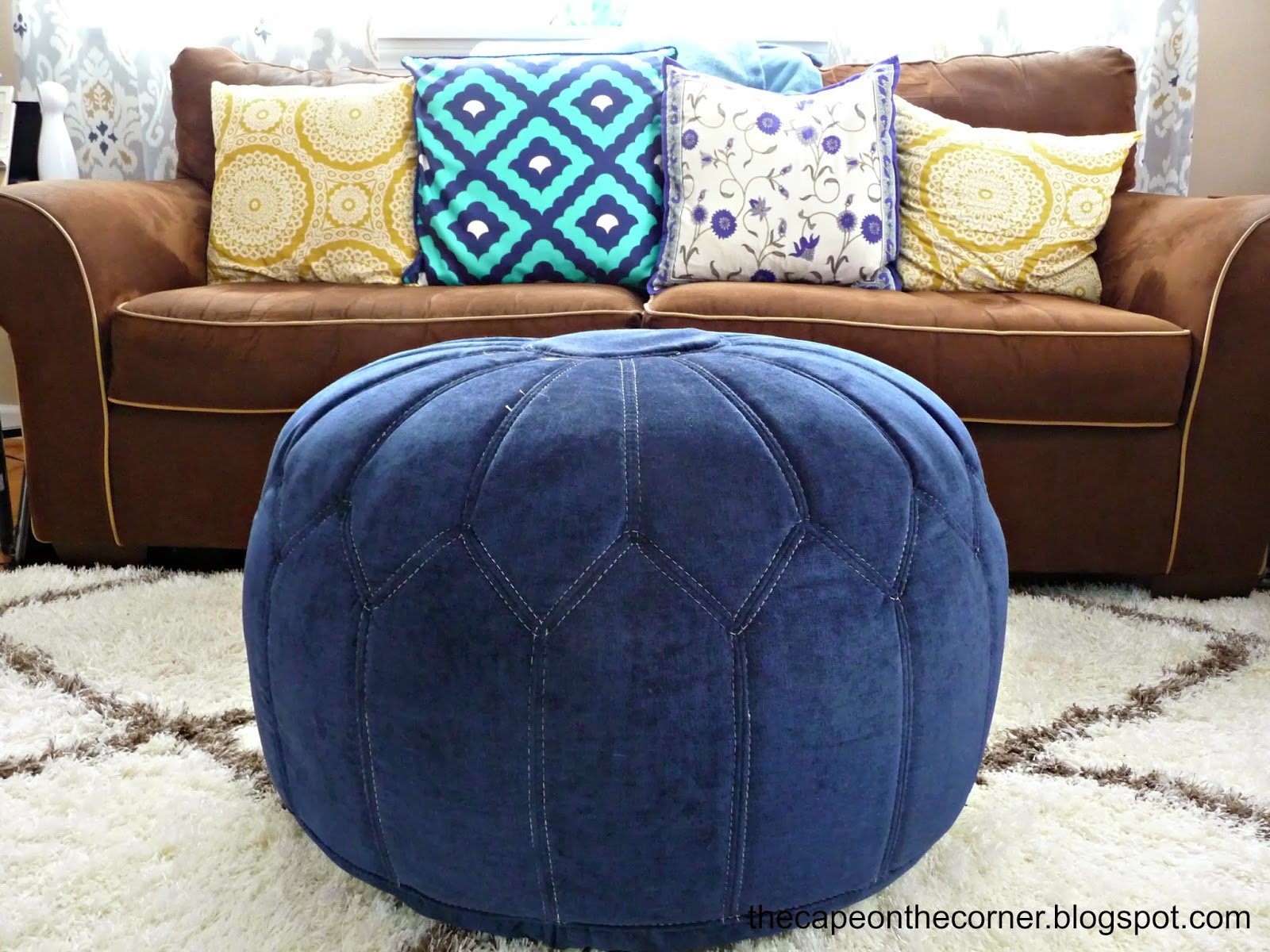 brown couch, blue poof, gold pillow