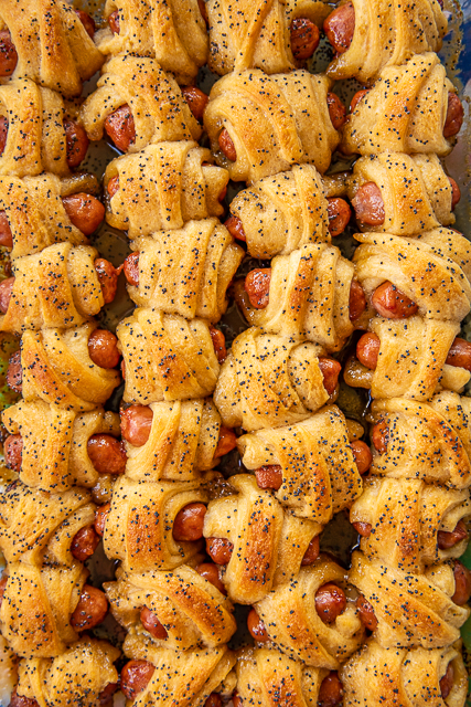 Glazed Pigs in a Blanket - pigs in a blanket baked in a sweet and savory brown sugar glaze. Took these to a party and they were gone in minutes!!! Crescent rolls, dijon mustard, little smokies, brown sugar, butter, poppy seeds and Worcestershire sauce. I have zero self-control around these things! Dangerously delicious!! A MUST for all your tailgates and parties! #tailgating #Pigsinablanket #partyfood #appetizer Glazed Pigs in a Blanket - pigs in a blanket baked in a sweet and savory brown sugar glaze. Took these to a party and they were gone in minutes!!! Crescent rolls, dijon mustard, little smokies, brown sugar, butter, poppy seeds and Worcestershire sauce. I have zero self-control around these things! Dangerously delicious!! A MUST for all your tailgates and parties! #tailgating #Pigsinablanket #partyfood #appetizer