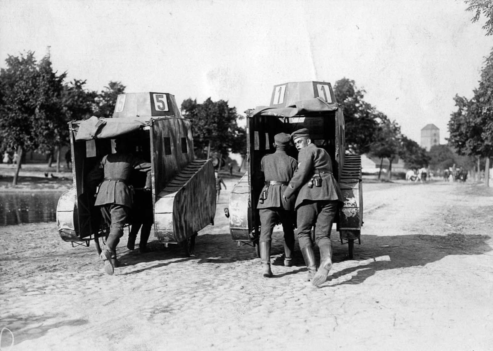 German soldiers push a pair of dummy tanks. 1925.