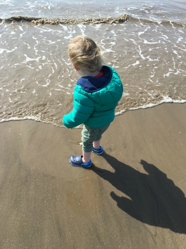 toddler at the edge of the sea