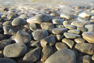 Smooth granite boulders on beach Almost lifeless boulder beach