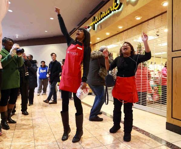 Two women from Macy's lead a chant 