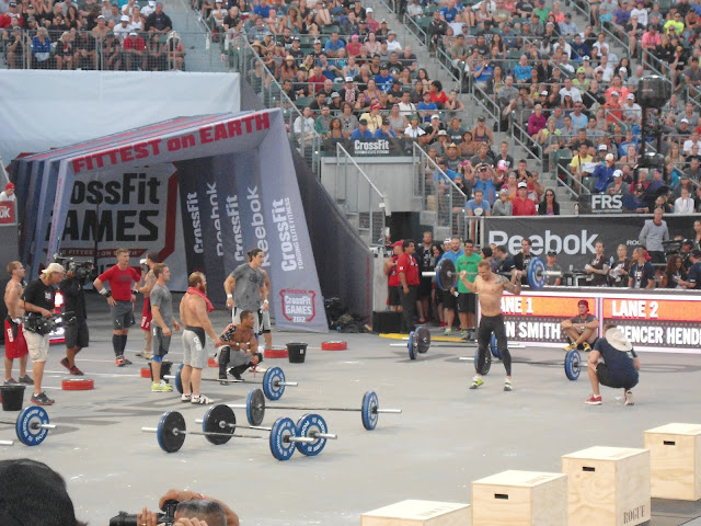 2012 CrossFit Games mens competitors cheering on another competitor as he finishes off his exercise
