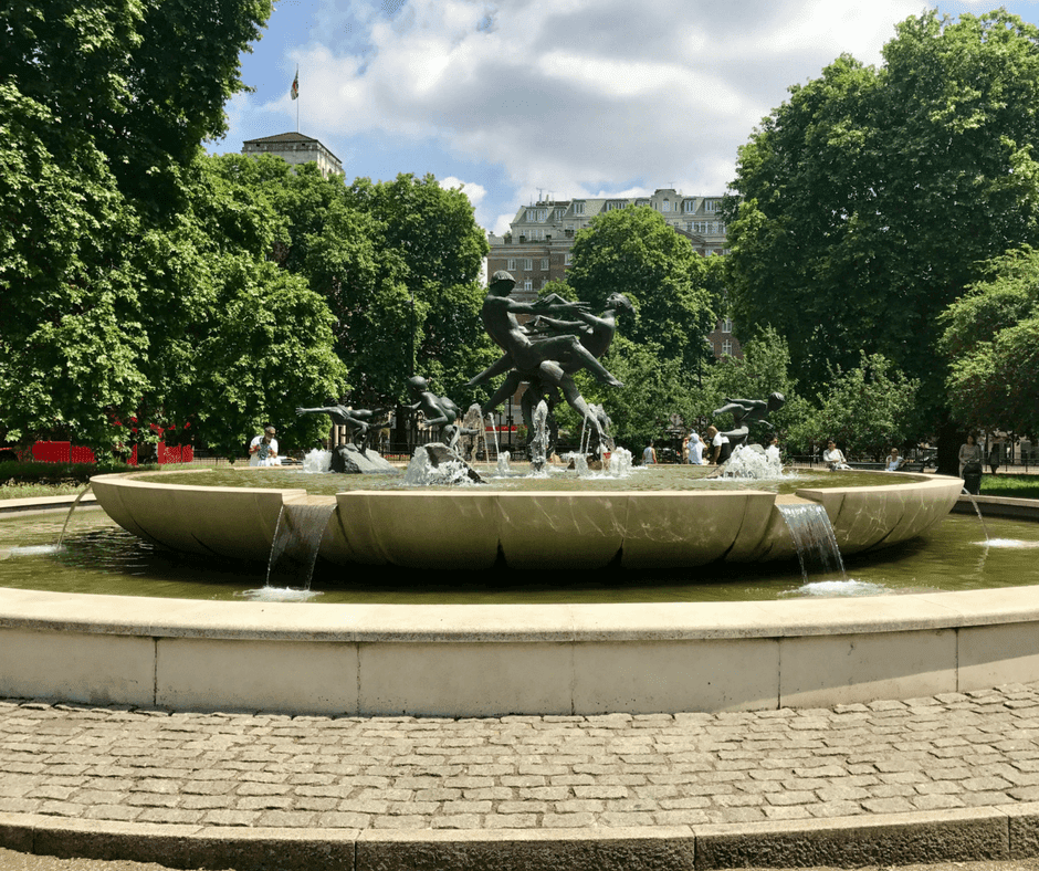 A fountain in Hyde Park, people playing in the fountain