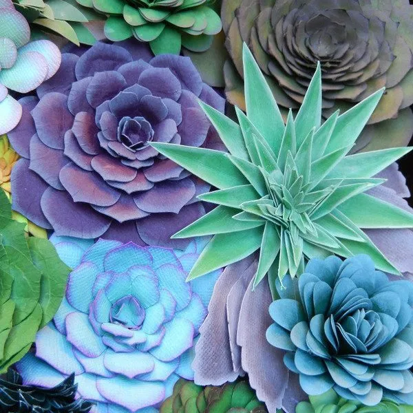 hand cut and sculpted paper succulents in greens, blues, and purples