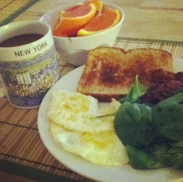 Weekend breakfast: Orange slices, fried eggs, coffee, toast, spinach salad and bacon
