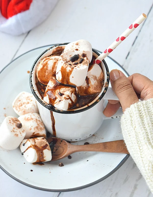 white mug with double hot chocolate topped with marshmallows