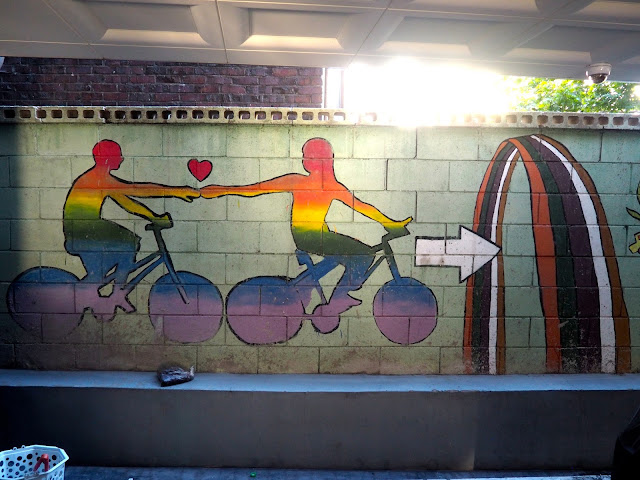 Rainbow coloured cyclists street art in the Haenggung-dong mural village in Suwon, South Korea