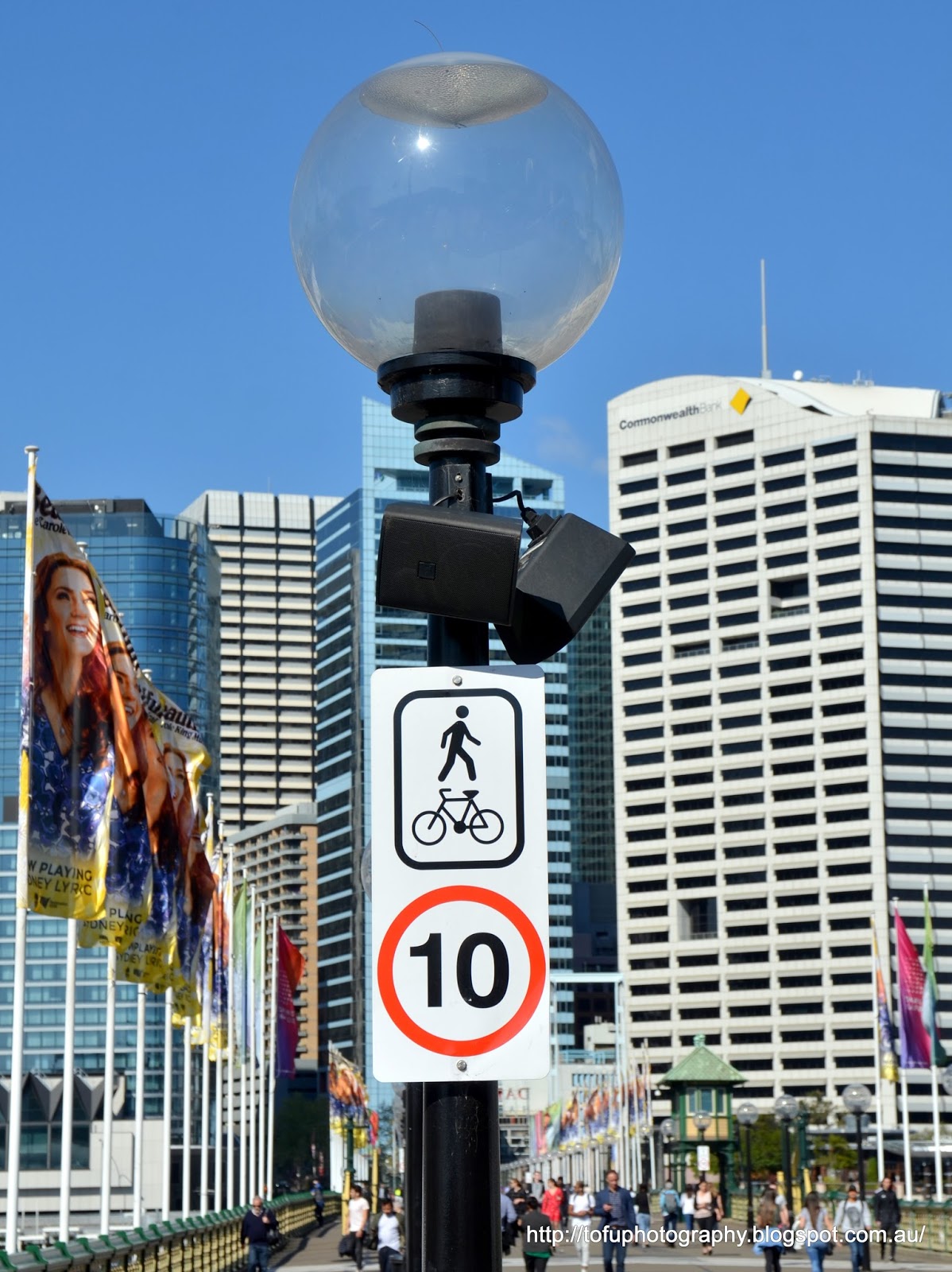 Tofu Photography A street light and a sign on a bridge giving the