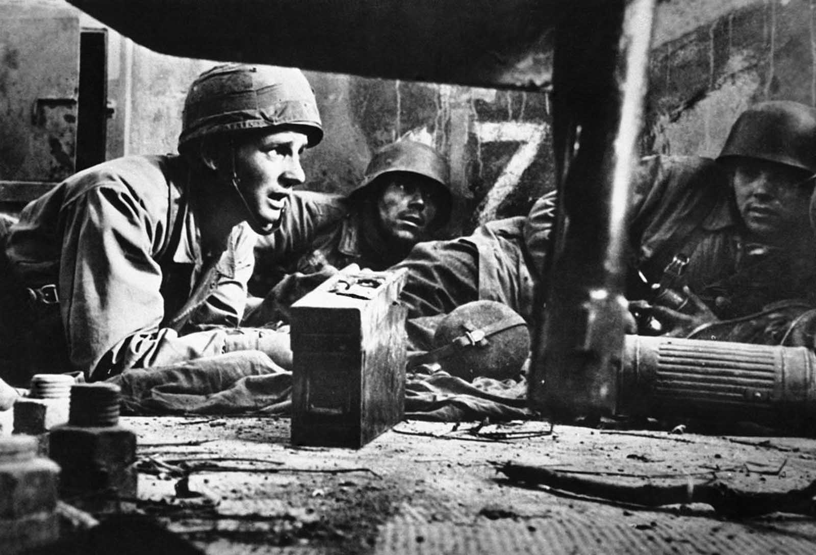 German infantrymen take cover in a house in southern Italy, on February 6, 1944, awaiting the word to attack after Stukas had done their work.
