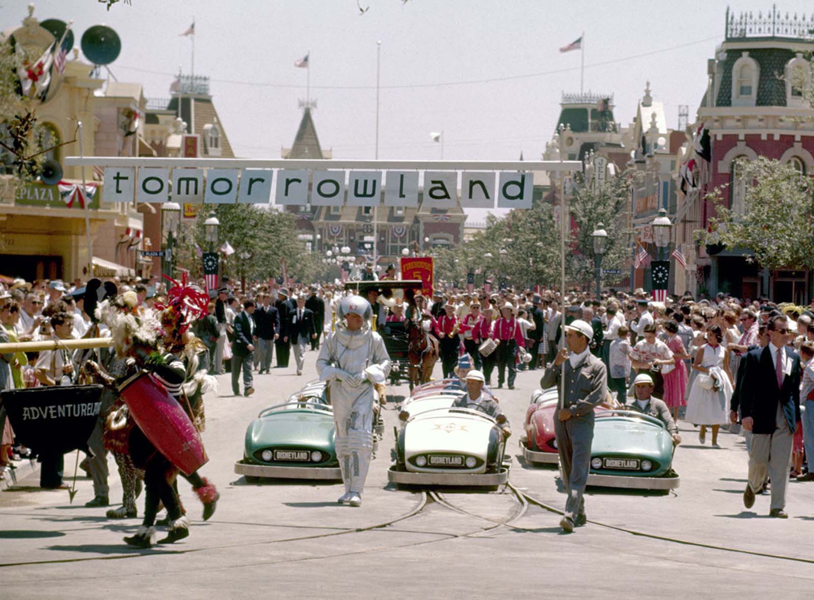 Crowds of people watch the Tomorrowland portion of a parade celebrating the opening of the Disneyland amusement park on July 17, 1955.