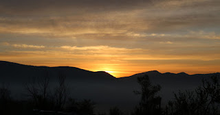 Golden glow as it rises past the ridge Golden glow as it rises past the ridge