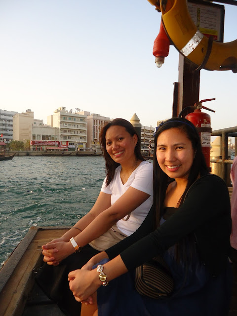 Lady and a friend riding an Abra in Dubai Creek
