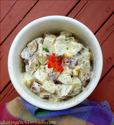 Apple Cider Chive Potato Salad, a new twist on a favorite picnic side dish | Recipe developed by www.BakingInATornado.com | #recipe #potato