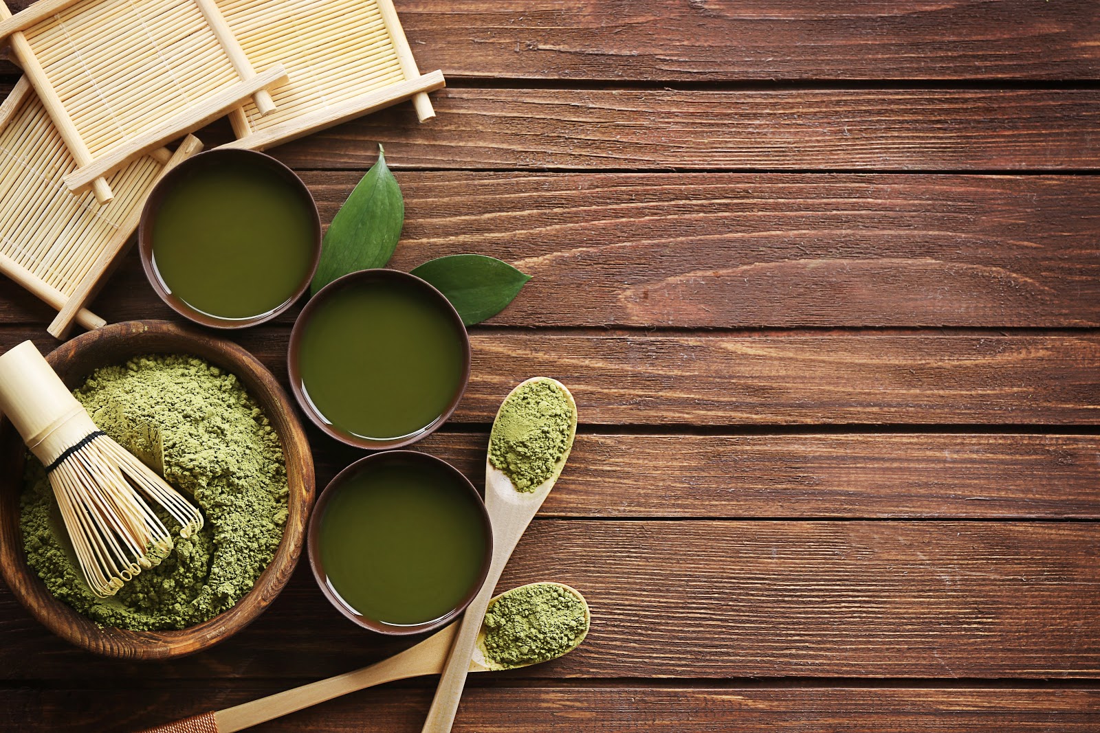 Bowl of Green Powder on Brown Wooden Surface Bowl of Green Powder on Brown Wooden Surface