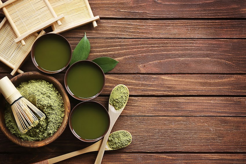 Bowl of Green Powder on Brown Wooden Surface Bowl of Green Powder on Brown Wooden Surface