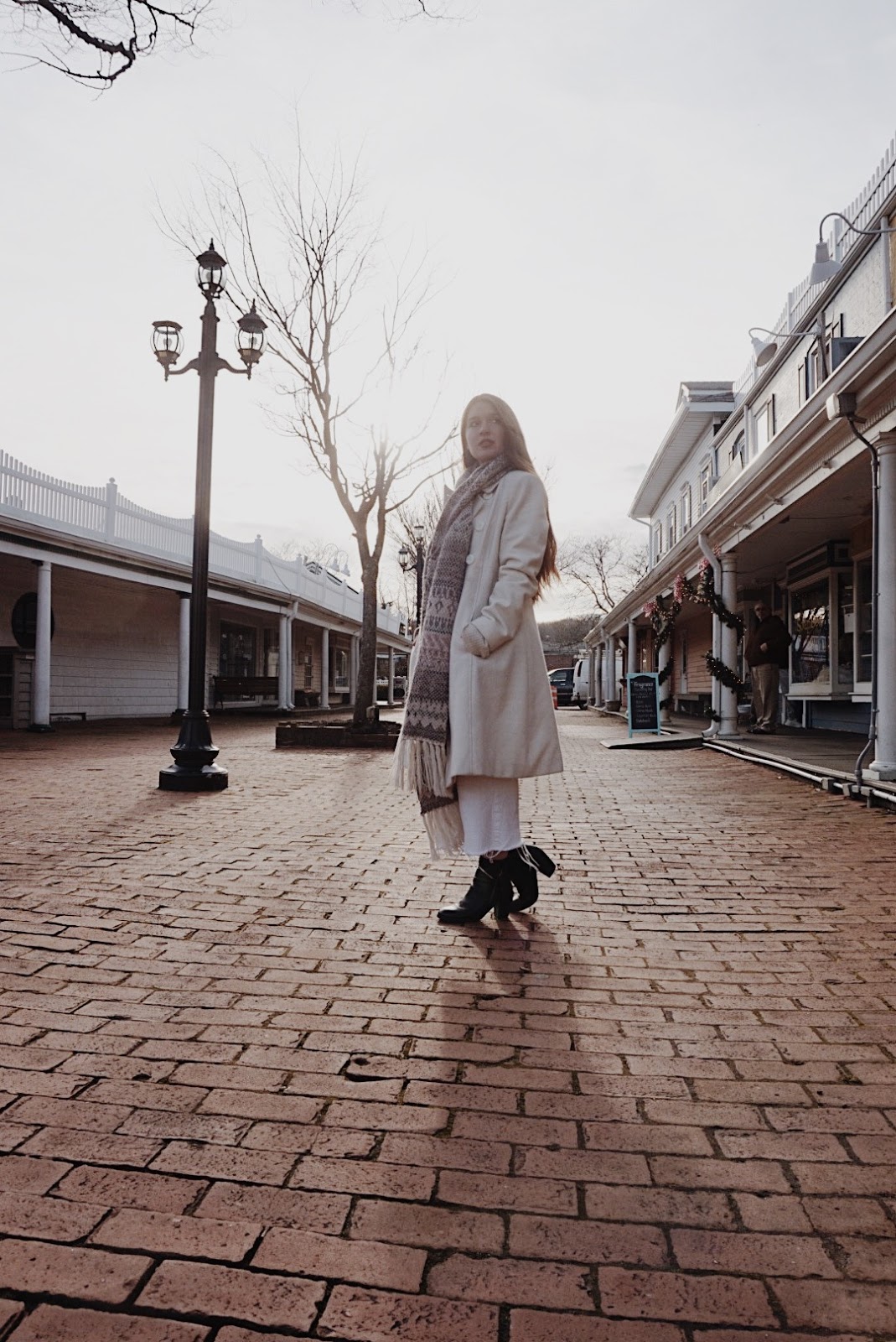 girl in winter outfit a girl modeling in a white winter coat and long scarf