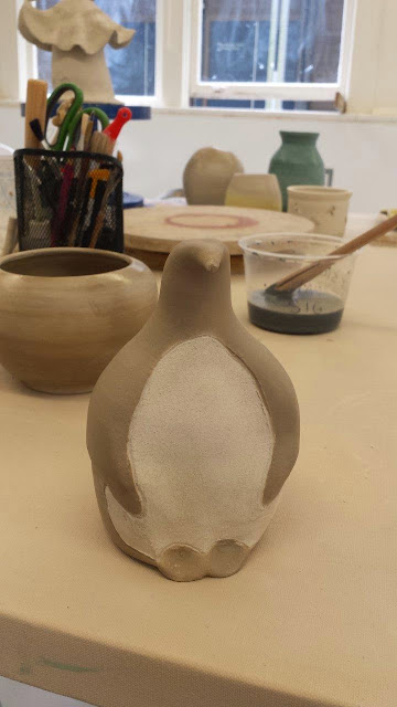 Raku pottery penguin in progress - after terra sigillata has been applied.