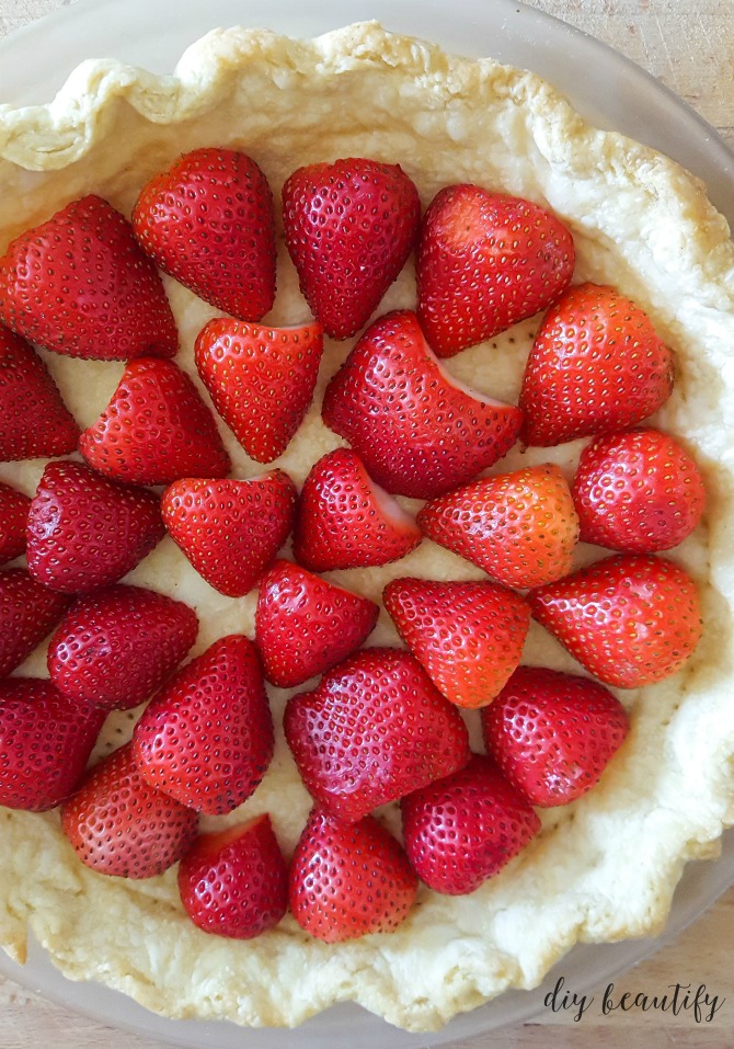 halved strawberries in pie crust