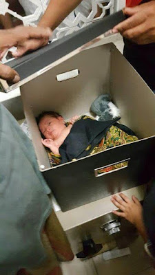 b Photos: Baby found abandoned in a carton with a letter