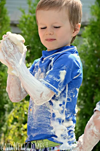 Child covered in colored shaving cream