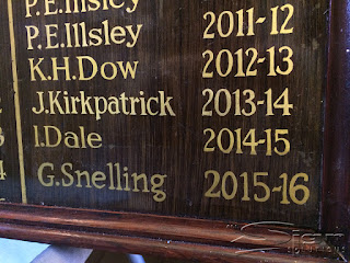 Freehand gold painted letters on honours board