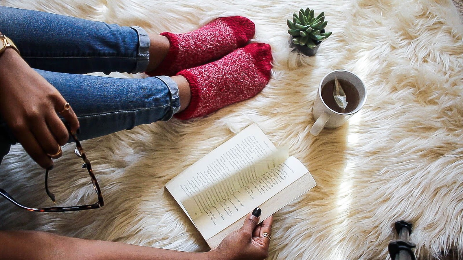 A girl with red socks is reading a book 