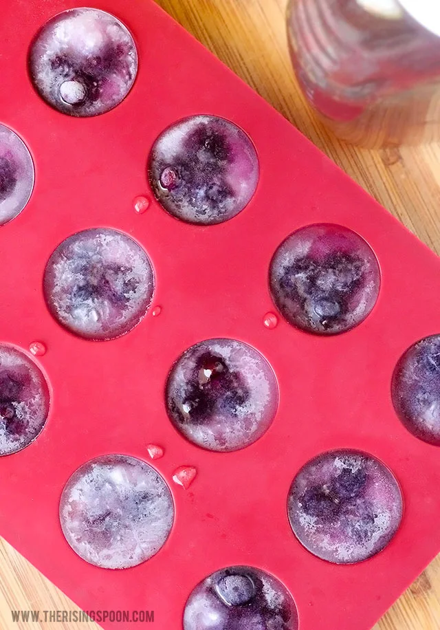 An easy recipe for healthy homemade pink lemonade using fresh squeezed lemon juice, raw honey, and blueberries!