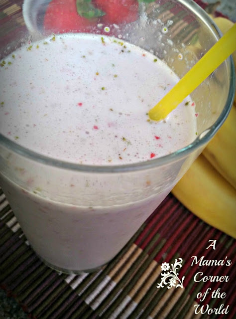 Strawberry Banana Smoothie in a glass with a yellow straw