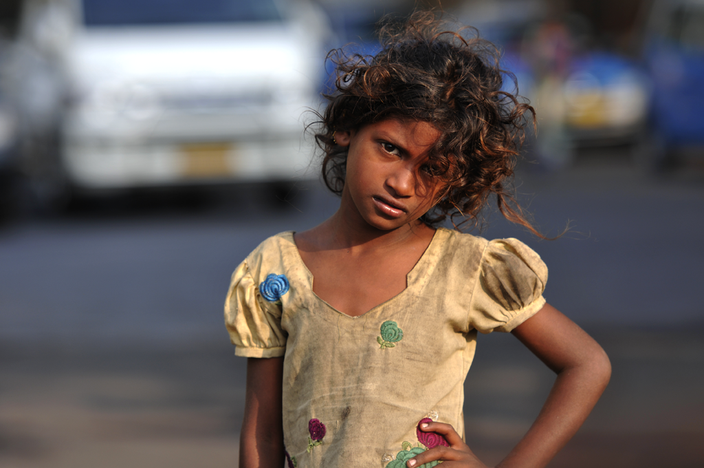 This is a photograph of street child in the Apollo Bandar area of Bombay in India.