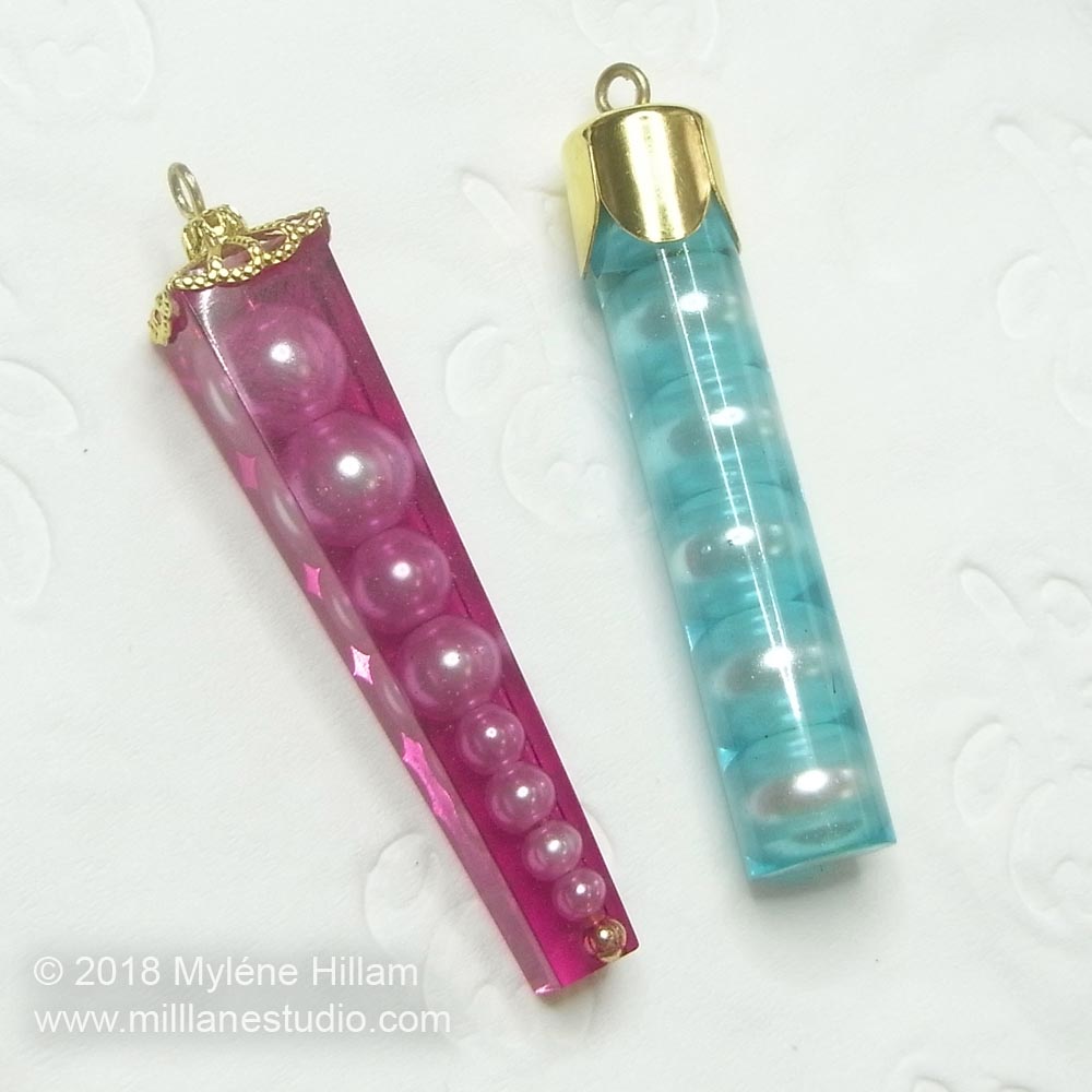 Resin crystal pendants with pearls captured inside.