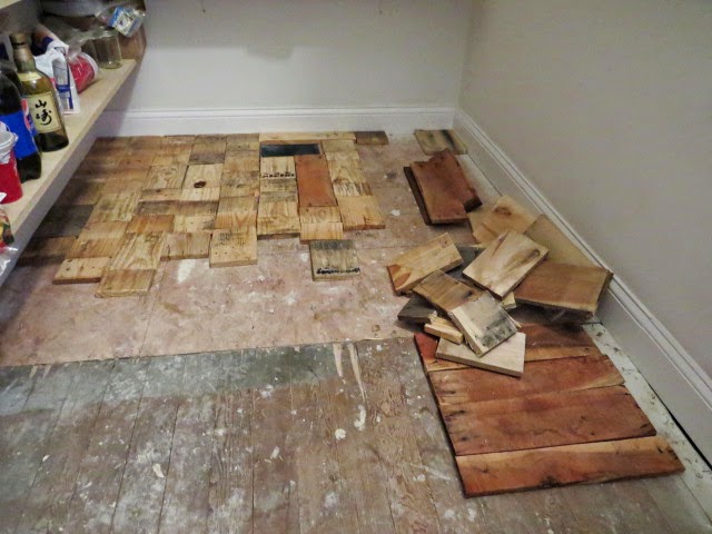working on pallet wood pantry floor