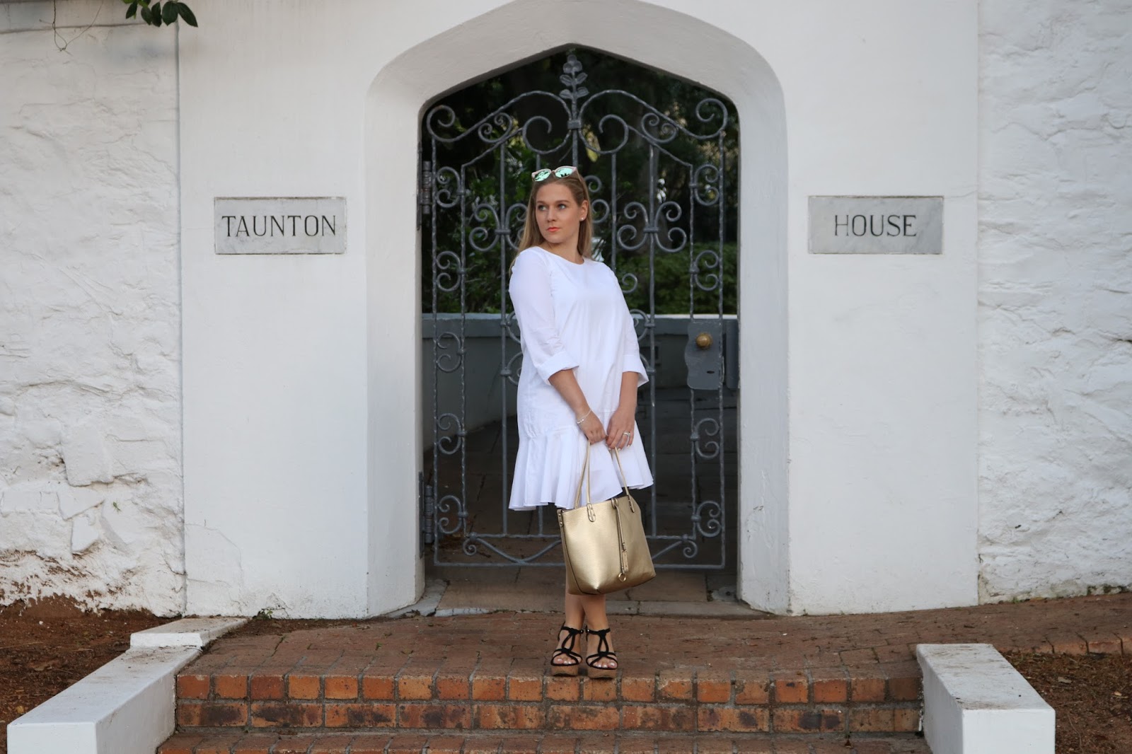 Katie Heath wearing white dress and wedges at the Belmond Mount Nelson Hotel