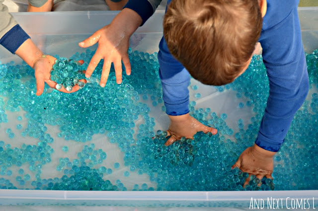 Kids playing with water beads in a sensory bin