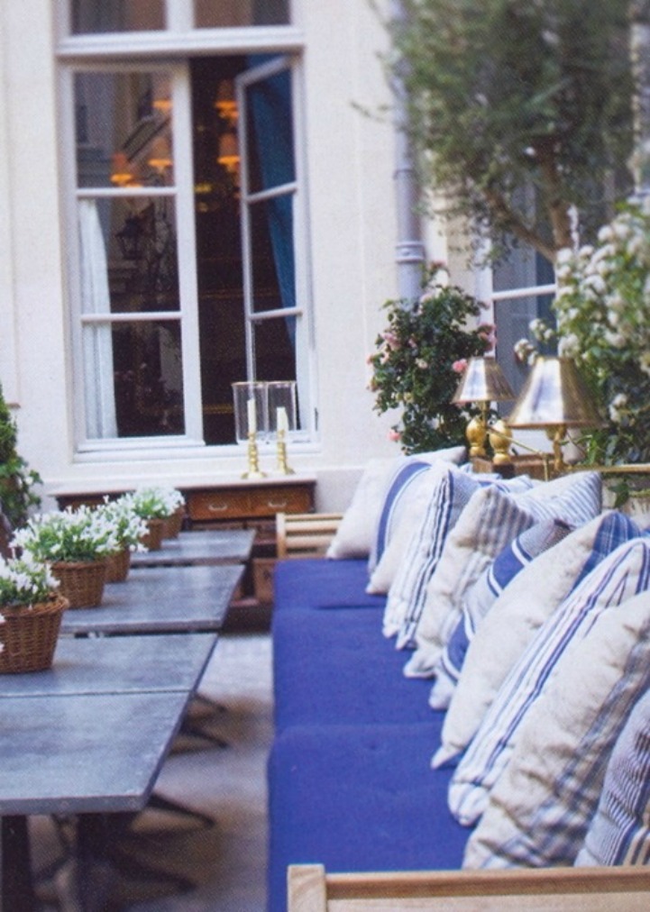 Coastal outdoor space with blue and white cushions