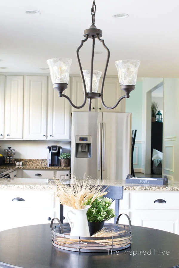 Farmhouse style kitchen makeover. Easy kitchen updates with painted cabinets, new hardware, and accessories.
