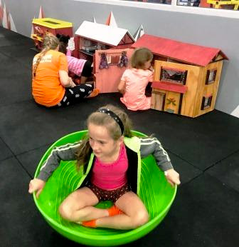 Girl in round container at The Kids Gym 