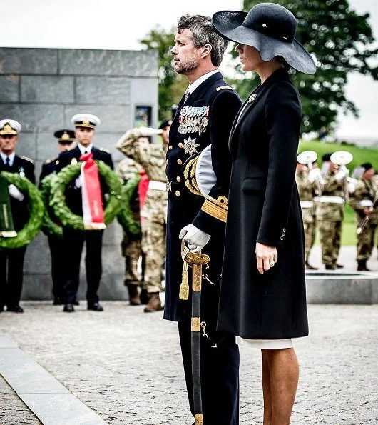 Prince Frederik and Crown Princess Mary at wreath-laying ceremony Prada Cappotto black coat. Gianvito Rossi Pumps, Hugo Boss clutch