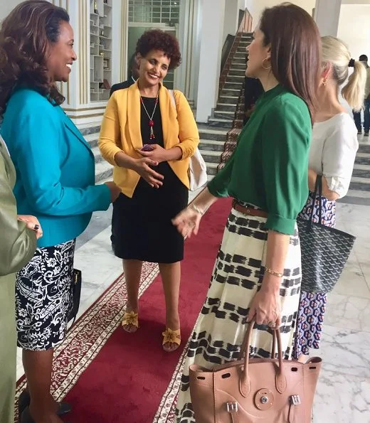 Tory Burch black and white pleated midi skirt and Etro skirt, a green silk blouse, Gianvito Rossi suede pumps, Ralph Lauren bag