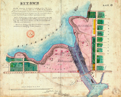 Map showing Ottawa mostly along the axes of Wellington/Rideau and Sussex, along with the Rideau Canal up the frist eight locks to the basin. Between Bank St and the canal is a pink area labelled Barrack Hill (now Parliament Hill) which extends south to overlap with the Wellington Street alignment. A narrow road (labelled old Road) swoops south around Barrack Hill to connect Wellington and Bank to the west end of Sapper's Bridge. Between the canal and the properteis along the west side of Sussex is marked Pink in what is now Major's Hill Park. In the crook of this curved road is a small area labelled Old Burial Ground. Properties north of Wellington, west of Bank, (Upper Bytown) and on both sides of Sussex (Lower Bytown) are painted green to indicate that they are properties sold off for private development. The street grid has been extended south of Barrack Hill overlapping the curved but still not including Wellington. The Old road crosses Sparks Street, which now connects directly with the west end of the Sapper's Bridge.