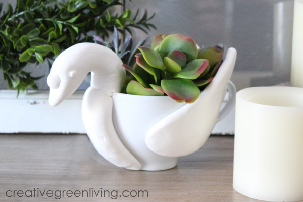 Succulent planter that looks like a swan made from a large tea cup and air dry clay