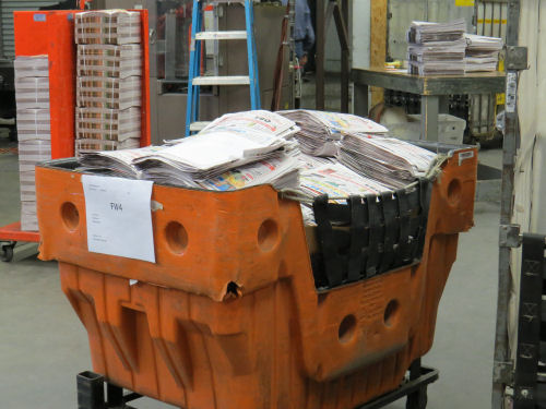 cart of newspaper bundles