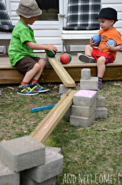 Kids playing with a homemade backyard ball run