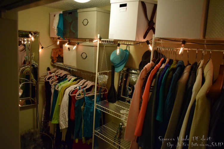 A small 8 x 6 closet space makeover using velvet hangers, upholstered storage boxes,Edison bulb light strands, armed chair and faux fur area rug.