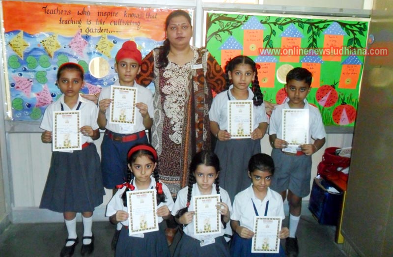 Winner shows certificates during Punjabi Recitation at BCM School