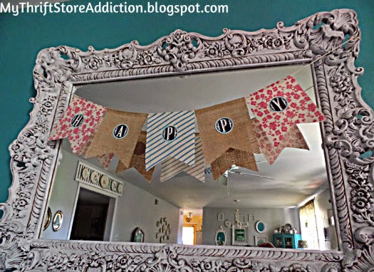 Upcycled "Happy" bargain banner hanging across gorgeous upcycled thrift store mirror: mythriftstoreaddiction.blogspot.com Gorgeous upcycled mirror